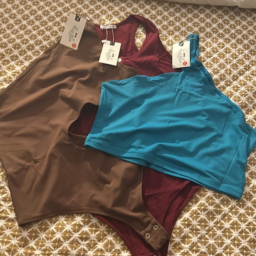 Selling two sexy curvy bodysuits and one sexy tank. 2 xl with tags